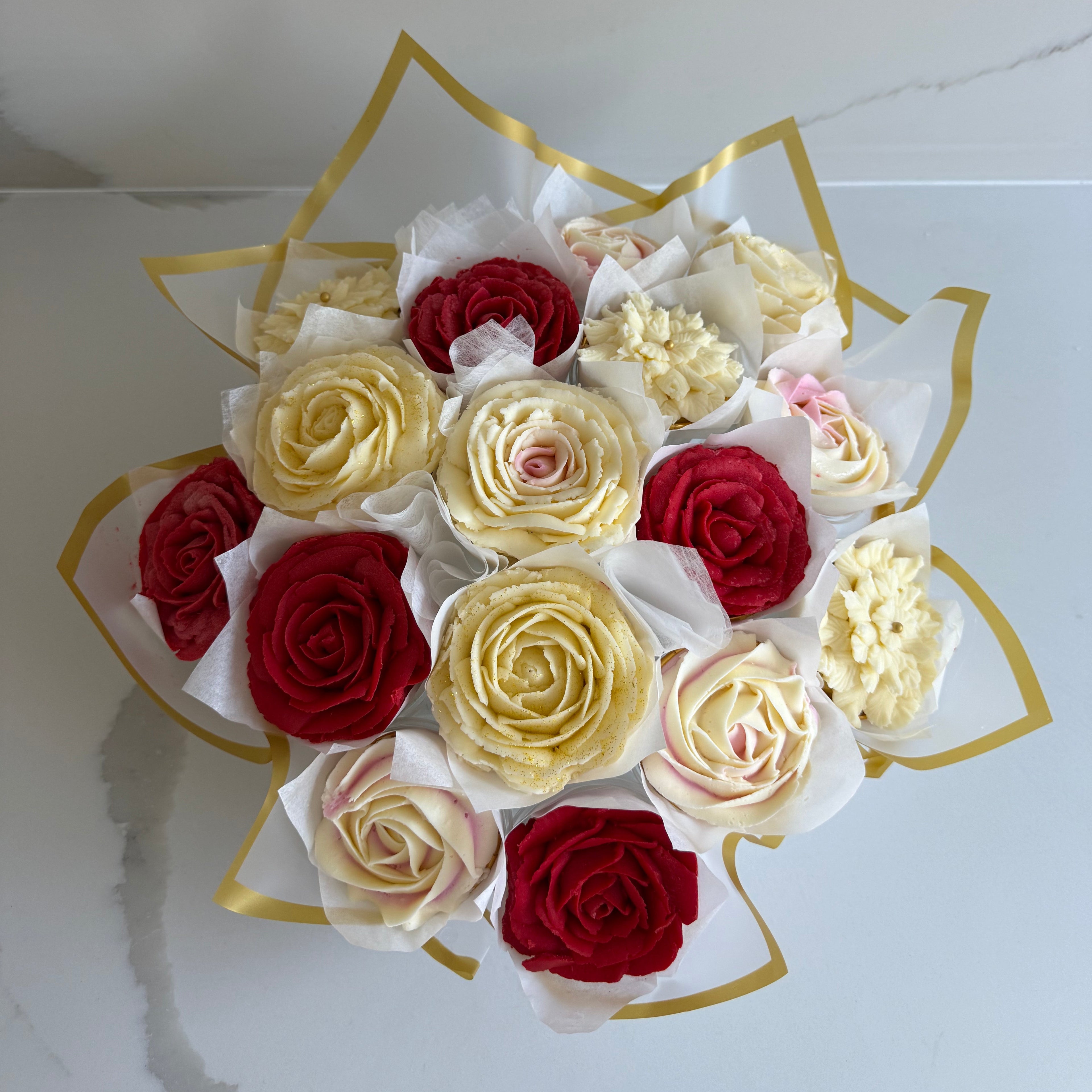 Cupcake Bouquet of red, white, and gold roses on a white background